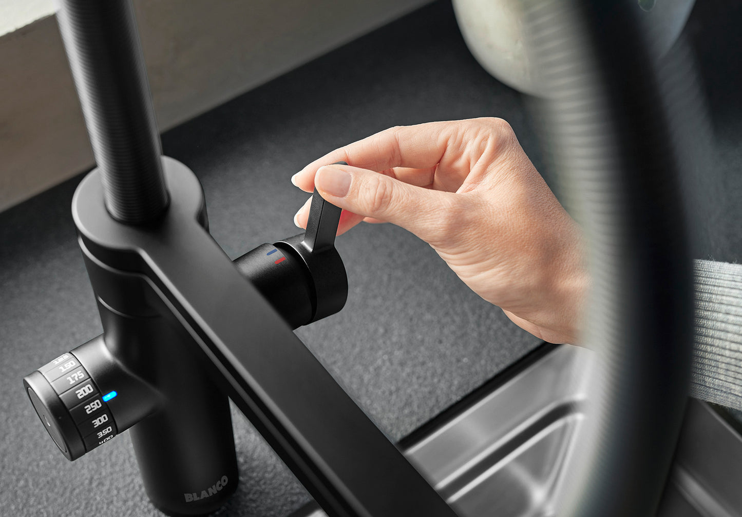 Close-up of the smooth ergonomic control lever on the BLANCO EVOL-S Pro Filter tap, highlighting the premium Black Matt texture and water temperature adjustment.