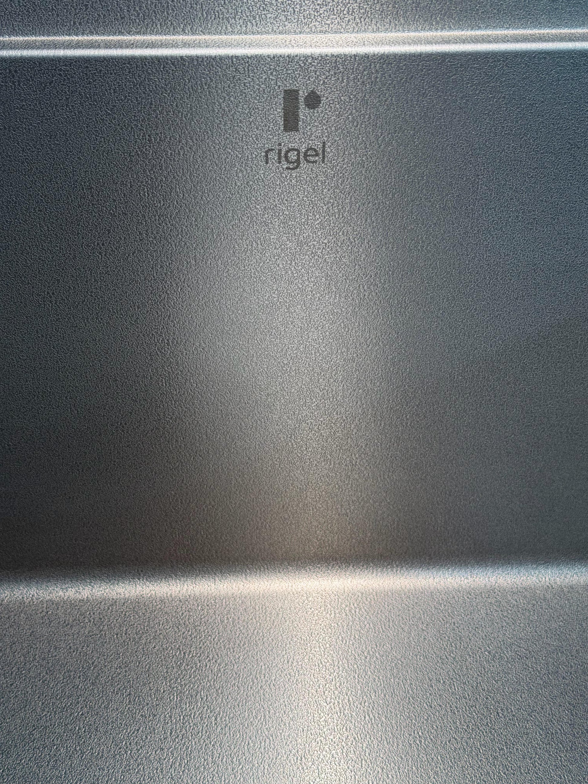 Metallic surface with 'Rigel' logo in the center